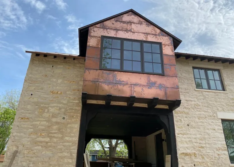 Copper metal panel facade on a stone building for Roof Repair in Camino Tassajara